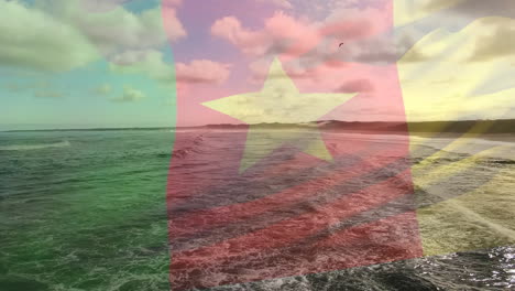 animation of flag of cameroon blowing over beach seascape