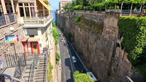 cars driving along a narrow street