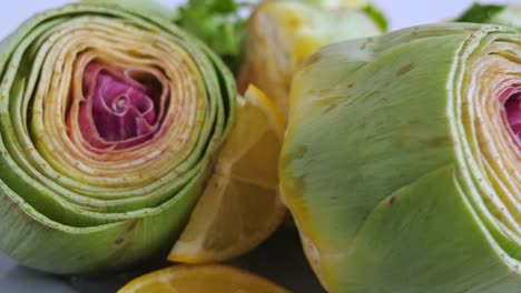 Cut-fresh-artichokes-on-plate,-rotating.-Closeup.-Nobody