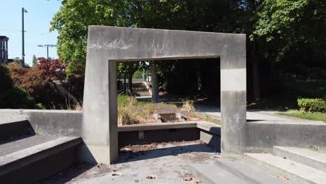 1-2mystical-druid-pathway-camera-fly-thru-modern-futuristic-dry-concrete-fountain-archway-on-a-hot-sunny-summer-day-at-a-contemporary-park-by-the-highway-freeway-road-in-a-tropical-city-of-paganism