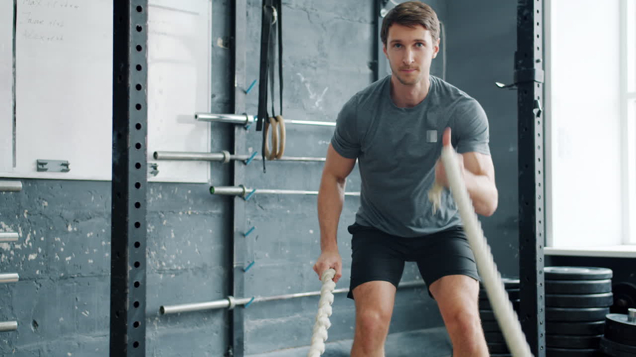 체육관 에서 로프 를 사용 하여 운동 하는 사람