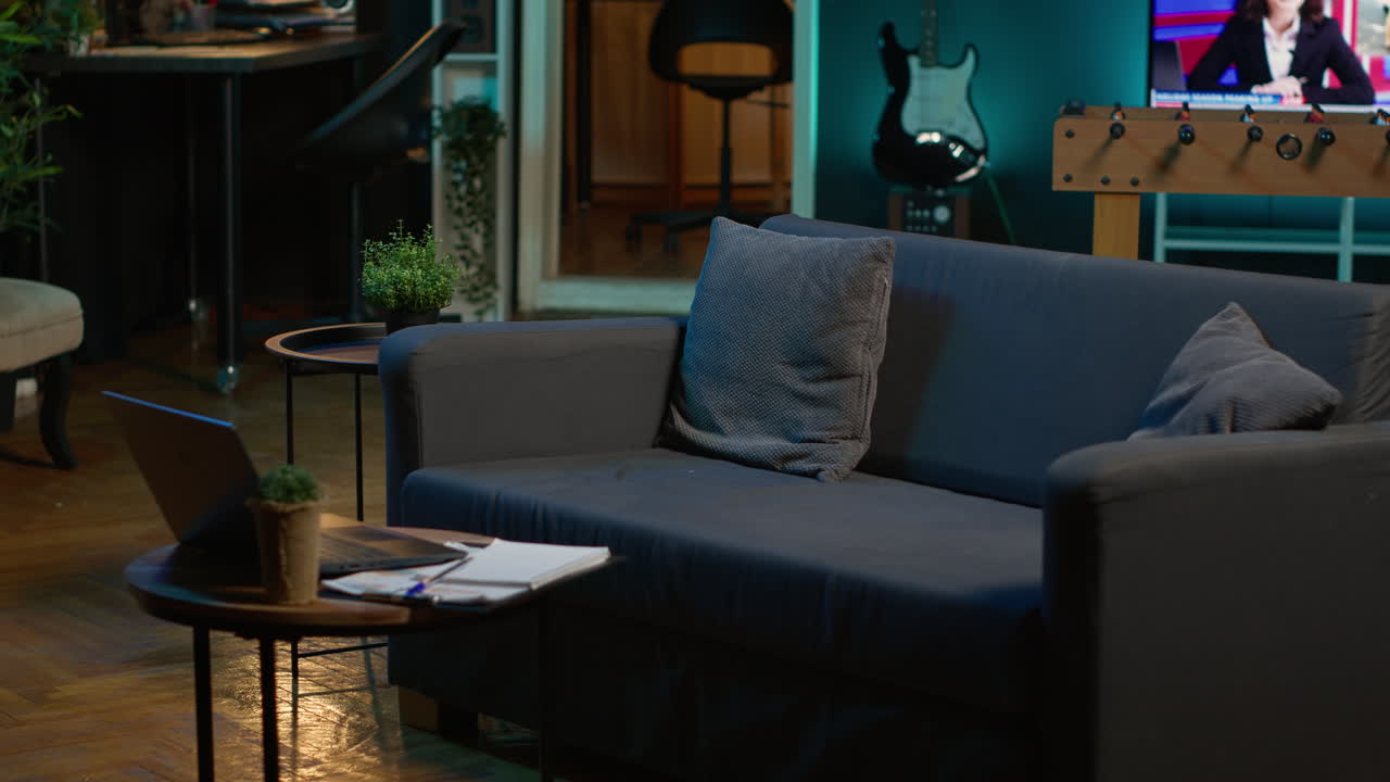 Empty contemporary studio apartment with modern decorations and equipment for a young adult, minimalist space decorated with led neon lights. Cozy urban loft with a home theatre setup.