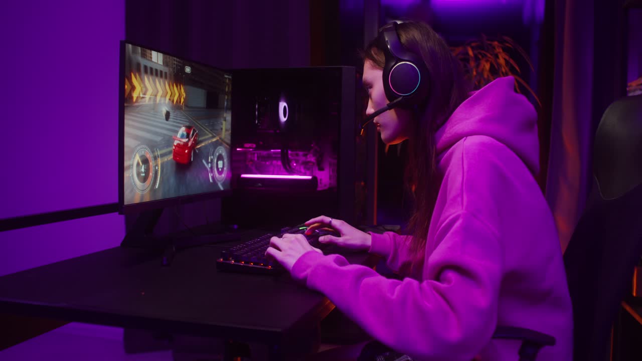 Woman Gaming at Computer with Purple Lighting