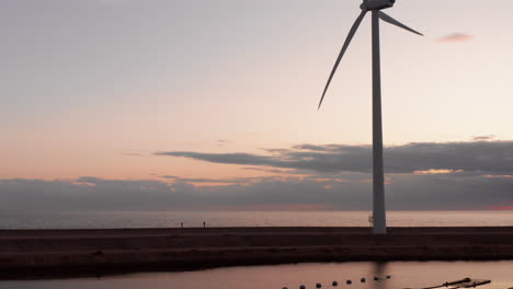 windturbines and aquaculture during sunset on the island neeltje jans, the netherlands