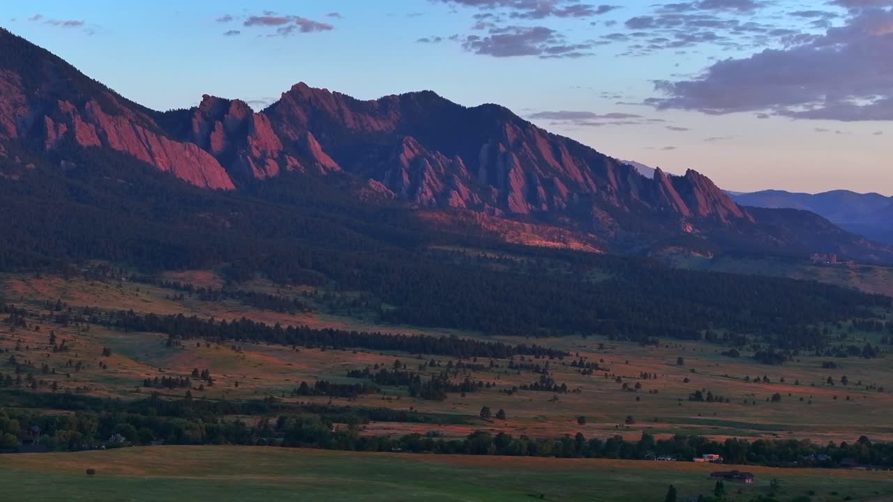 Cows Flatirons Front Range Boulder Chautauqua Park morning sunrise aerial drone Colorado spring summer pink cloud first light on red slanted scenic nature Rocky Mountains parallax circle right