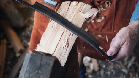 top down view of artisan craftsman shaving log on lathe