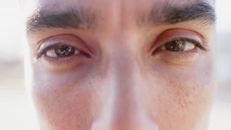 Portrait-close-up-of-eyes-of-happy-biracial-man-looking-at-camera,-slow-motion