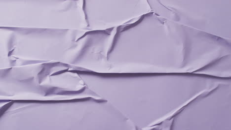 video of close up of violet creased fabric with copy space