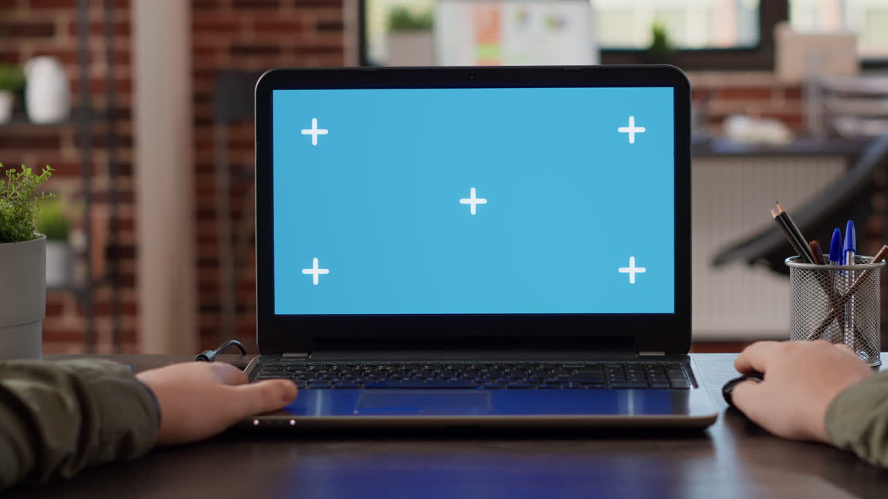 POV of male freelancer using laptop with greenscreen