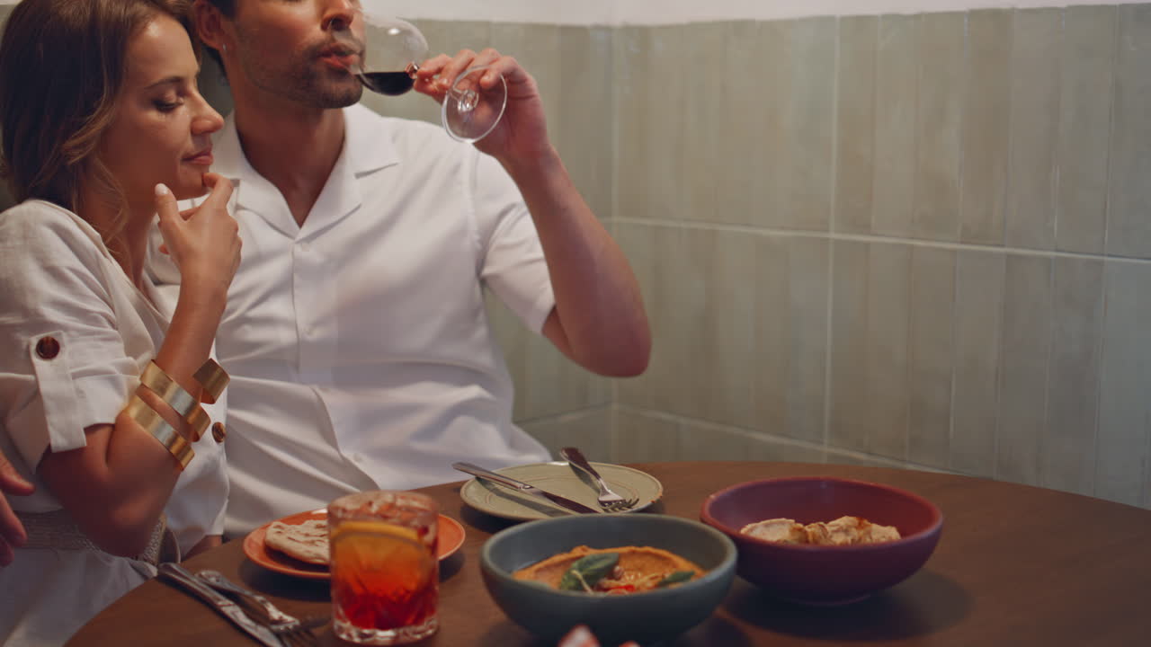 jóvenes cónyuges abrazando una cita en un café de primer plano. mujer sonriente disfrutando de los toques de un hombre