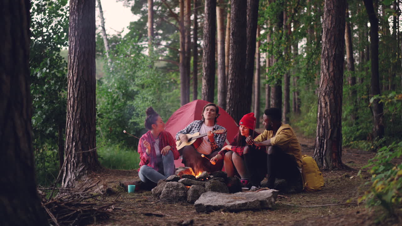 Friends enjoying a campfire in the forest