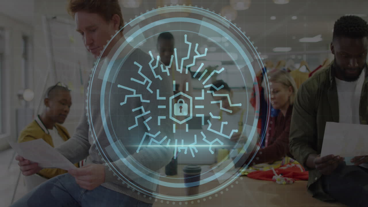 Animation of cyber security text and lock icon over diverse fashion designers working in studio