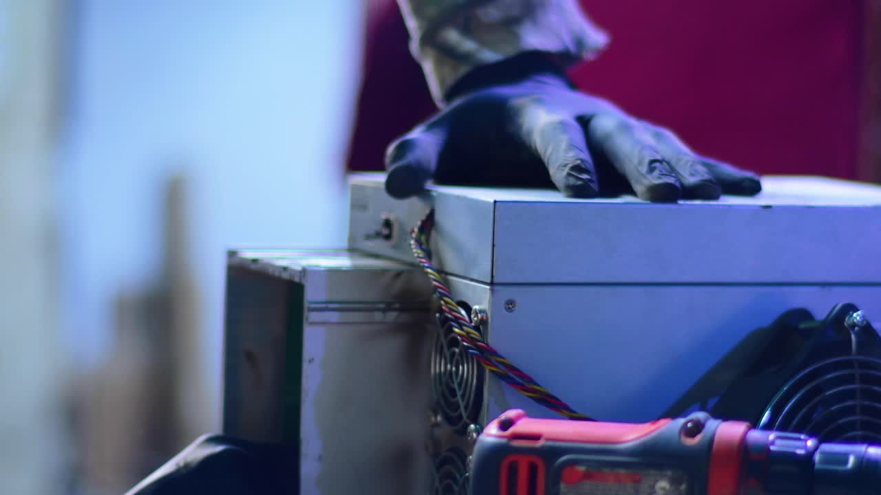 Technical operation under dramatic blue and red lights, focusing on server hardware installation or troubleshooting