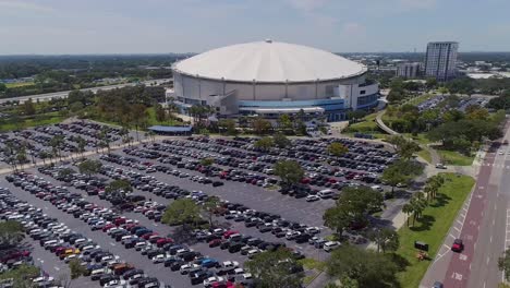 4k aerial drone video of tropicana field and full parking lot in downtown st