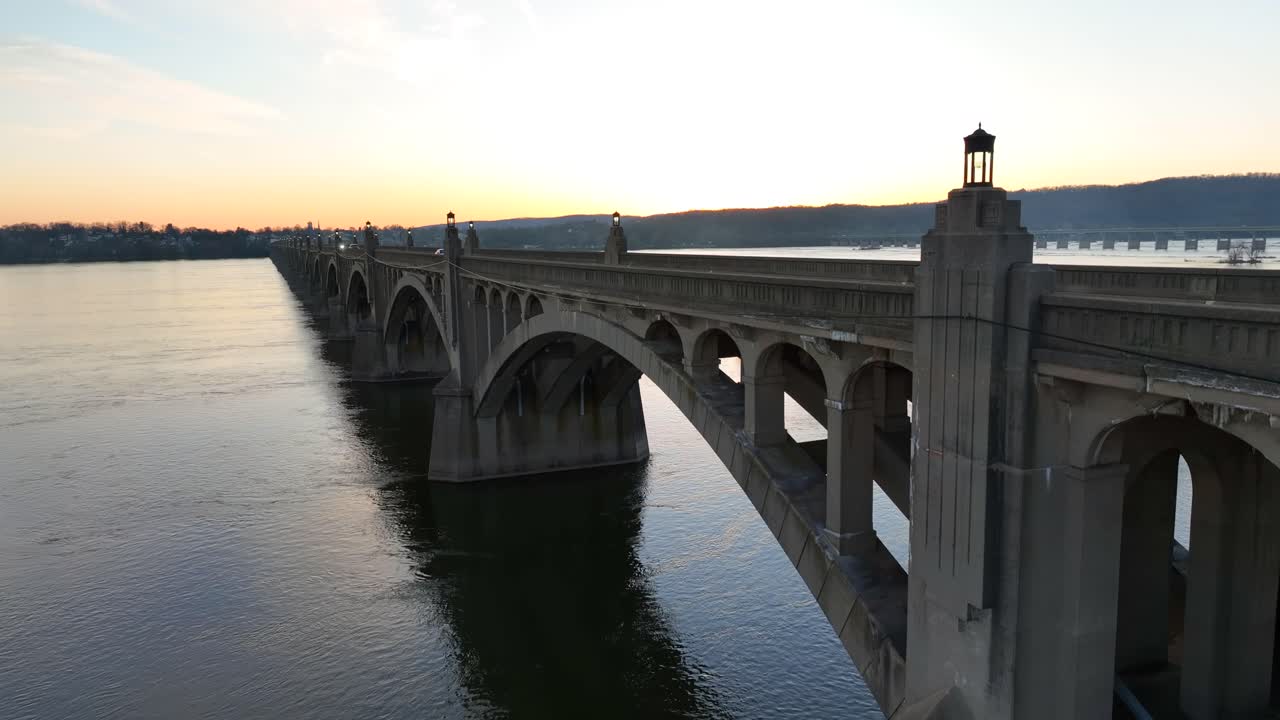 Traffic on Columbia&ndash;Wrightsville Bridge over Susquehanna River with beautiful sunset behind hills in background - Columbia Borough,Pennsylvania
