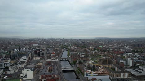 Backward-drone-shot-of-downtown-Dublin-with-bridges-across-River-Liffey