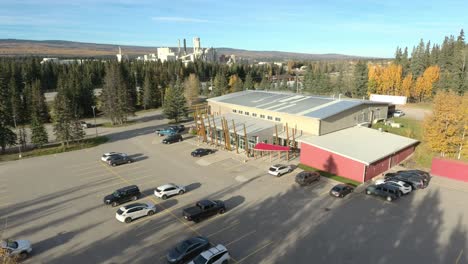 drone smooth shot of a building and a parking lot