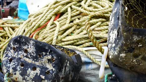 tangled fishing ropes and plastic bucket trap harbour equipment maritime accessory dolly right