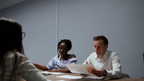 the board of directors reviews the chart on the projector and discusses possible movements in market success and the company's performance. applause after the final speech of the director of the company. joyful news and smiles of employees after the