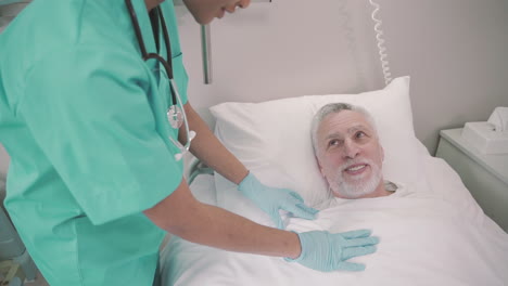 Bedridden-Patient-Feels-Comfortable-And-Safe-With-His-Nurse,-An-Unrecognizable-Young-American-Girl