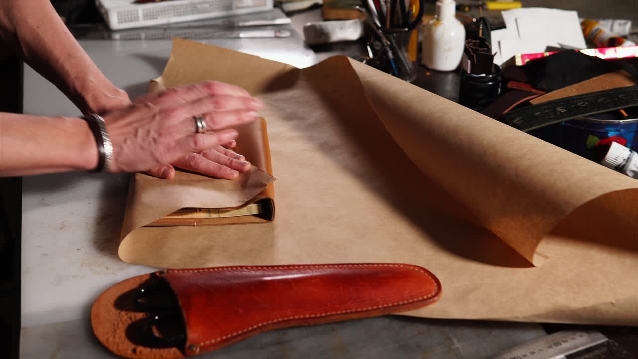 Wrapping Leather Holster in Brown Paper
