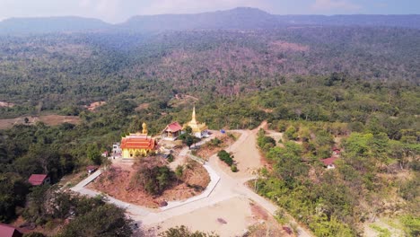 remote isolated pagoda with buddha ans stupa in dry arid laos countryside