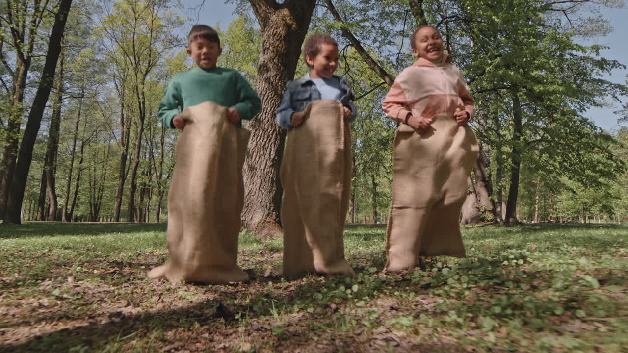 Children enjoying a sack race in the park