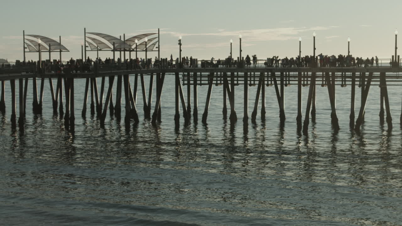 Sunset at the historic Redondo Beach Pier, a landmark of the South Bay coastline. Anglers and visitors gather above the Pacific as golden hour light reflects on the water and the pier’s architecture