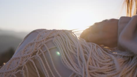 woman making macrame art at sunset
