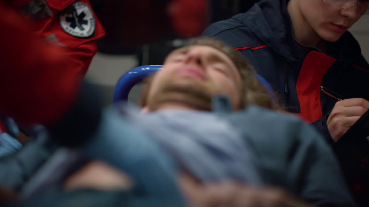 응급 차량 에 있는 환자 에게 구급차 도움 을 주는 ms 구급차 직원 들