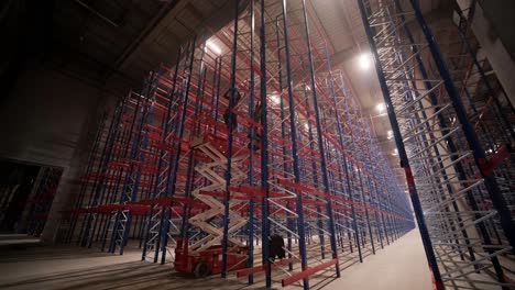 big and modern warehouse under construction, featuring metal shelving and other industrial equipment.