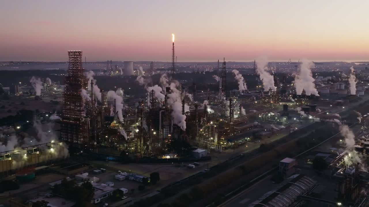 Energy industry plant: Oil refinery at sunset, showcasing industry process