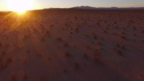 a beautiful fast moving low aerial over the mojave desert at sunrise or sunset 2