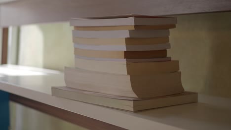 books stacked on a white shelf