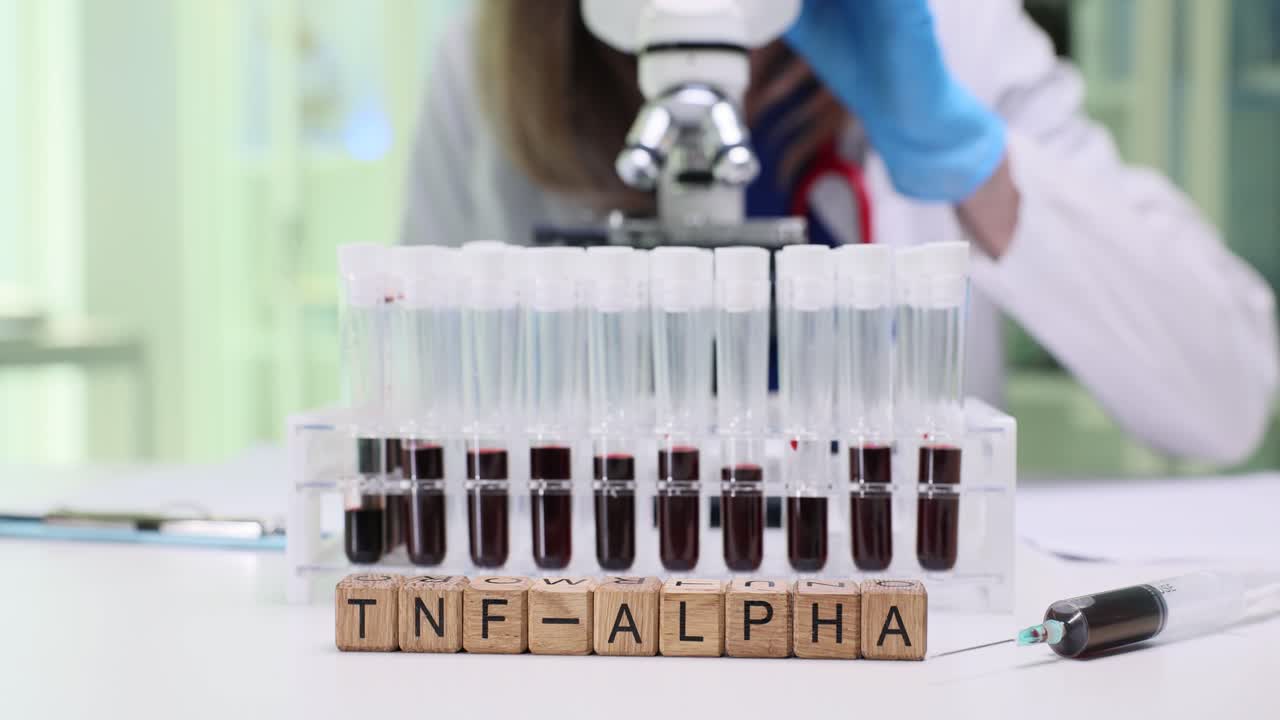 Scientist Analyzing TNF-alpha Blood Samples in a Laboratory