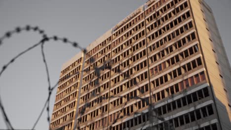 barbed wire near multistage building under sunset sky