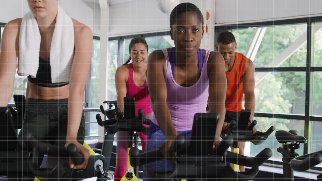 Four cyclists mounting exercise bikes and pedaling, powering animated data graphs in spin class
