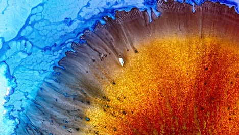 macro shot of vibrant blue and red ink diffusing in water, creating an abstract, coral-like pattern