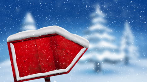 animación digital de nieve cayendo sobre un poste de cartel de madera roja contra el paisaje invernal