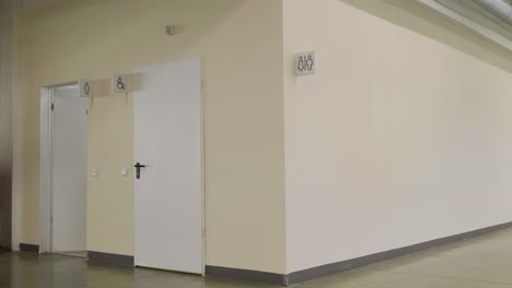 empty corridor with restroom doors