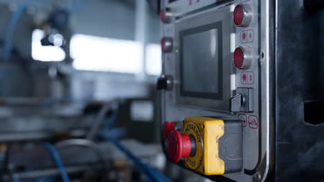 Factory-machine-conveyor-controller-with-buttons-showing-production-data-closeup