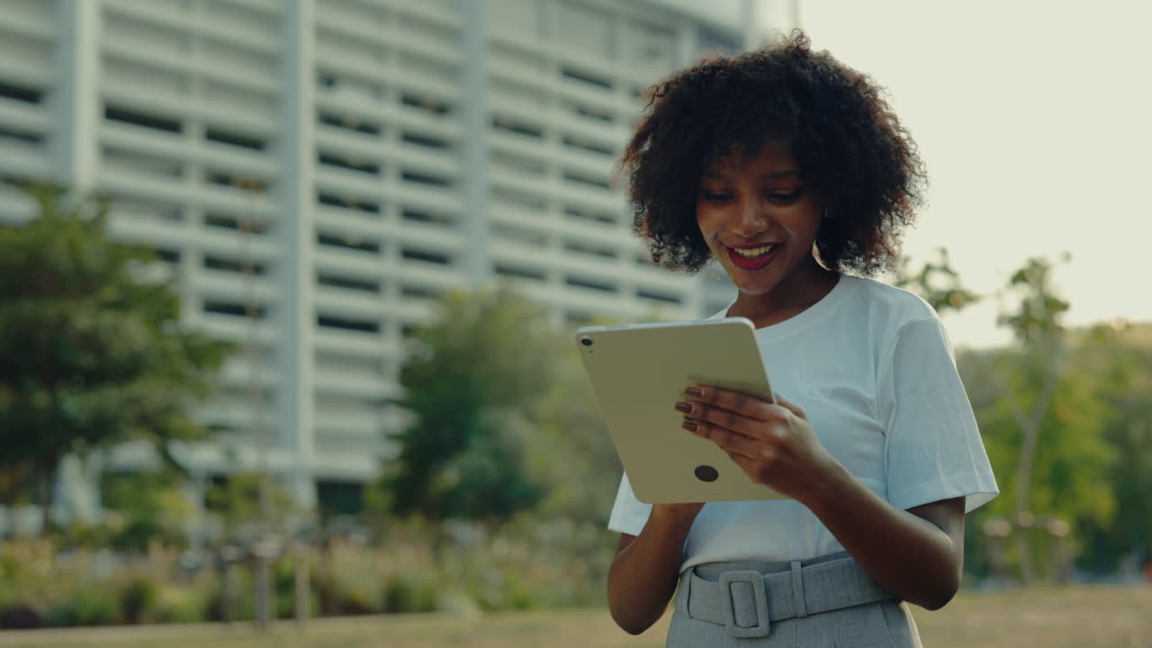 Young Woman Using Tablet in Park