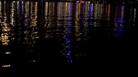 city lights reflecting on water at night