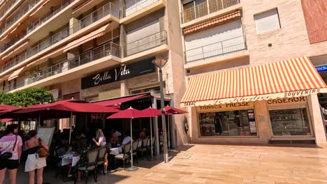 tourists walking past shops and cafes