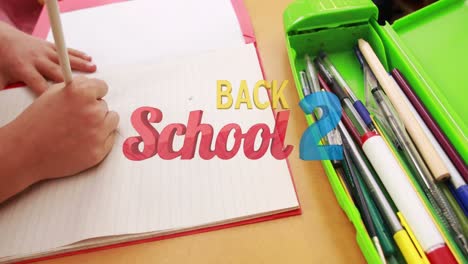 animation of back to school text over caucasian schoolgirl writing in notebook