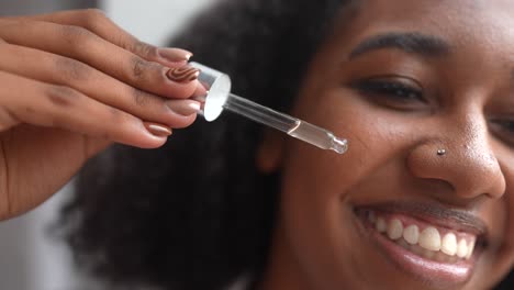 woman applying facial serum