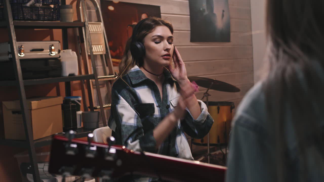 Rock Girl Listening To Music In Headphones In Studio