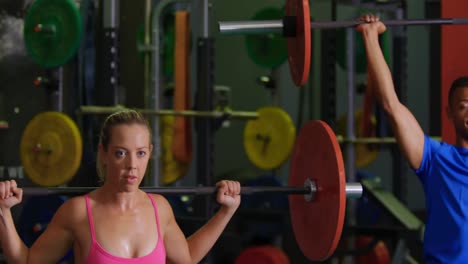 man and woman exercising in a gym