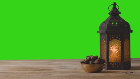 tracking shot of lantern dates and water in front of a green screen