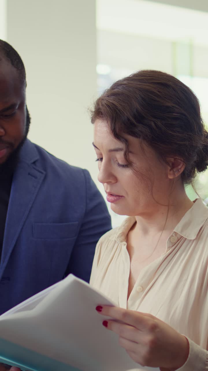 Diverse Business Colleagues Discussing Documents in Office
